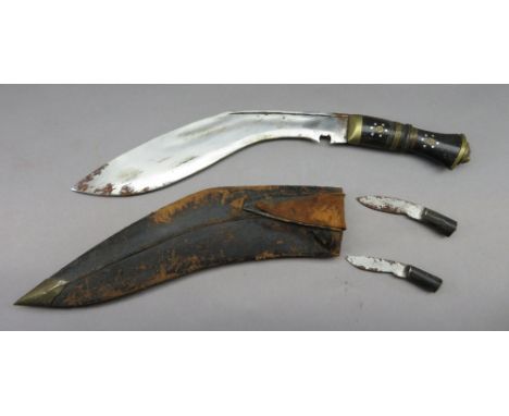 A NEPALESE DAGGER (KUKRI), 20TH CENTURY of characteristic form, with broad curved single-edged blade, in its scabbard complet