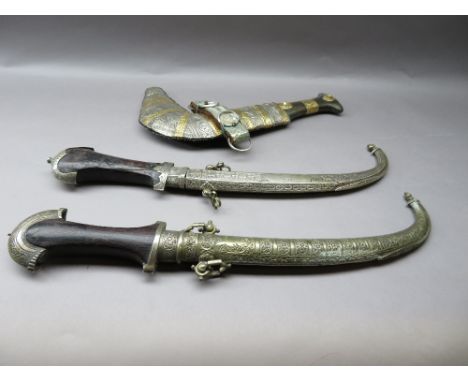 TWO MOROCCAN DAGGERS (JAMBIYA) AND AN ARAB DAGGER (JAMBIYA), FIRST QUARTER OF THE 20TH CENTURY the first with curved blade do