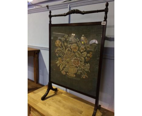A mahogany fire screen