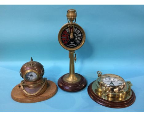 A reproduction Ships clock, a clock inset into a Divers helmet and a Ships Telegraph lamp (3)