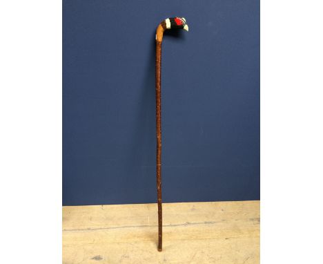 Carved beech wood walking stick, with a decorative handle in the form of a pheasant head