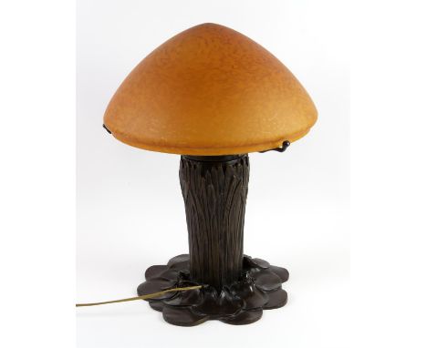 Art Nouveau-style cast-metal table lamp, in the form of lily pads and rushes, with mottled orange shade. Height 48cm approx. 