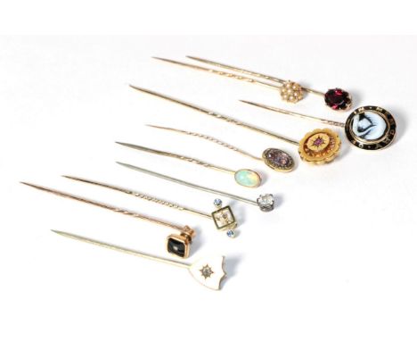 Ten gold and gilt metal stick pins including opal set, seed pearl set, diamond set and mourning examples .  Gross weight - 14