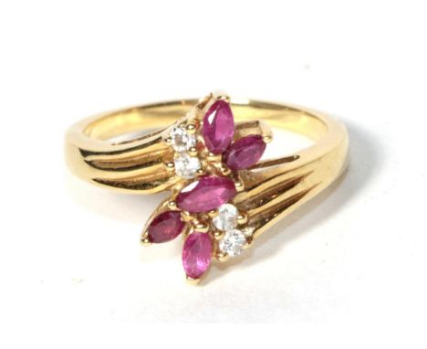 A ruby and diamond spray ring, stamped '18K', finger size N.  Gross weight - 4.9 grams 