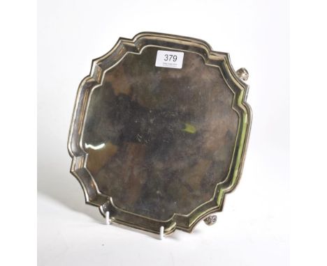 A shaped square silver salver, R &amp; W Sorley, London 1931, on four scroll supports, 26cm wide, 20.8ozt.  No engravings or 