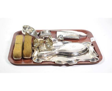 A part silver dressing table set, including a shaped rectangular tray; a cigarette case, of curved form, engraved with a mono