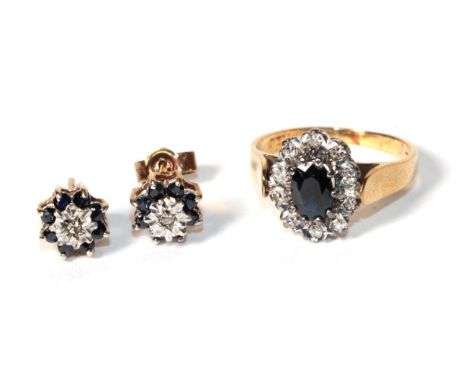 A diamond and sapphire cluster ring, stamps rubbed, finger size K; and a similar pair of earrings .  Gross weight - 4.40 gram