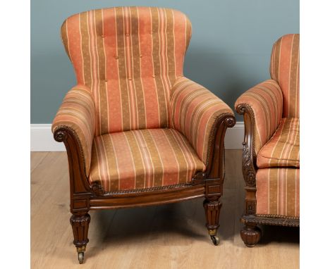 An early Victorian carved mahogany arm chair With button-back upholstery in gold and pink striped upholstery and with out scr