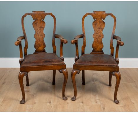 A pair of George I-style walnut open armchairs With leather drop in seats. Each bearing Hamilton Antiques labels to the frame
