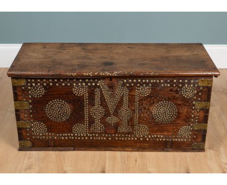 An antique hardwood Zanzibar chest The chest brass bound with brass studded decoration, and with iron carrying handles.95cm w