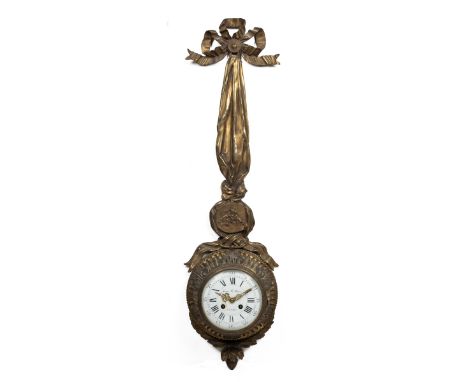 An antique French wall clock  The gilt brass case in the form of a ribbon-tied swag supporting a fluted drum-shaped case, the