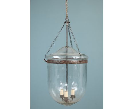 A large cut glass storm lantern With a repeating floral decoration to the bowl and a three-branch light within.Approximately 