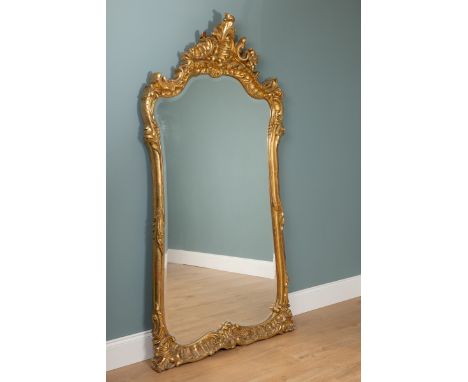 A gilt carved-wood pier mirror With a scrolling crest and further foliate decoration to the frame and a shaped mirror plate.1