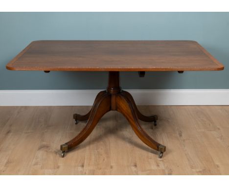 A mahogany tilt-top dining table The rectangular top with a cross-banded border, raised on quatreform legs, of modern manufac