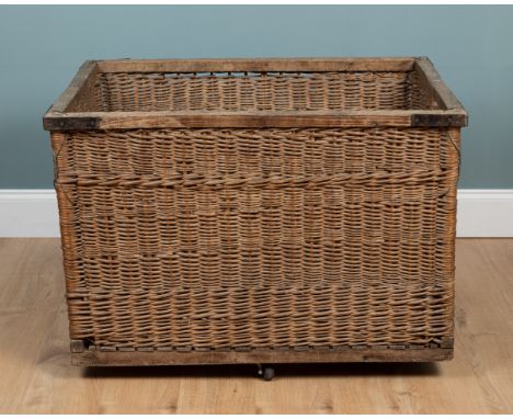A wicker log basket With an iron-bound, wooden lip and base.100cm wide x 70cm deep x 71cm highQty: 1In generally good conditi