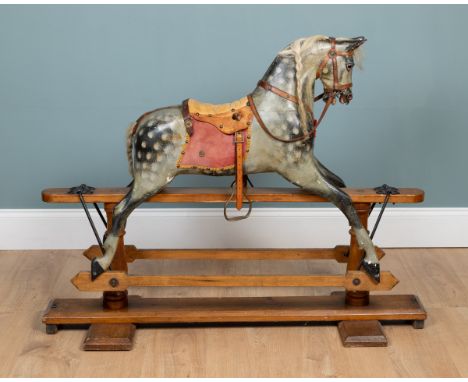 An early 20th century rocking horse The grey-painted horse on a sled base.128cm long x 100cm highQty: 1Some hair missing from