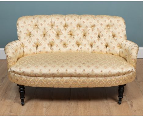 A Victorian silk-upholstered button-back sofa The two-seater sofa raised on turned front legs with castors.140cm wide 78cm hi