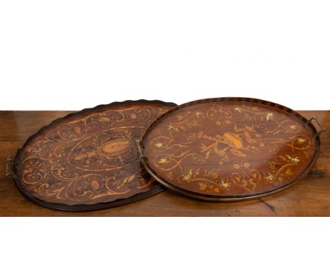 Two early 20th century mahogany oval trays With inlaid foliate decoration.The first 72cm wide x 48.5cm deep. The second 67.5c