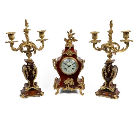 A late 19th century French garniture de cheminée The mantel clock and pendant two-branch candelabra with gilt metal mounts, t