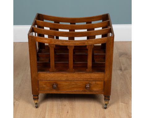 A mahogany three-section Canterbury With a fitted drawer and raised on turned feet with brass caps and castors.52cm wide x 42
