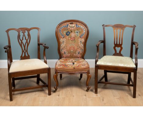 A group of three chairs Two 19th century mahogany Chippendale-style elbow chairs with carved splats and square section legs u