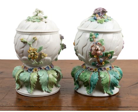 A pair of Chantilly potpourri vases Each c.1750 and decorated with flowers, with pierced lids, bases moulded with scrolling l