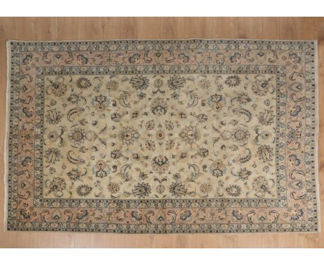 A handmade Kerman-style carpet With a cream ground and foliate decoration.300cm x 195cmQty: 1In generally good condition with
