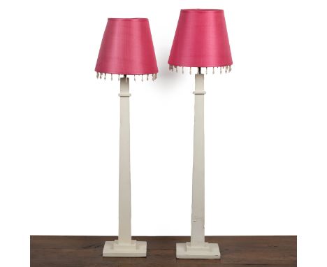 A pair of Laura Ashley white-painted obelisk-shaped table lamps With pink tasselled shades.77cm highQty: 2Some chipping to th