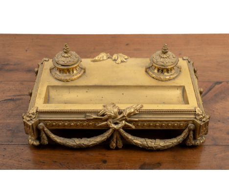A 19th century French ormolu desk stand With a hinged lidded inkwell and sander, a pen rest to the front, the body with guill