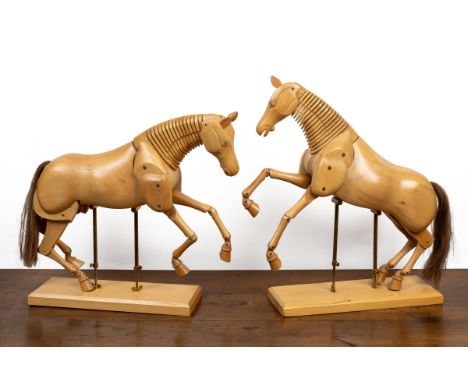 A pair of wooden articulated lay horse models The horses mounted on adjustable supports.39cm wide x 14cm deep x 54cm high (ad
