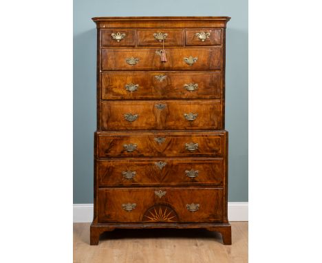 A George II walnut chest on chest with canted fluted corners enclosing an arrangement of three short over six long graduated 