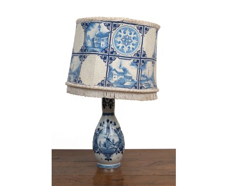 A modern Delft table lamp With a matching shade.37cm high to the fittingQty: 1Some surface dirt to the shade. Scratching arou