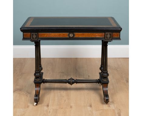 An Aesthetic Movement ebony and walnut card table The rotating top with storage underneath, folding out to reveal a blue baiz