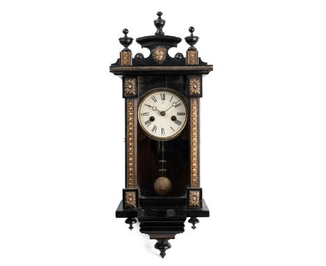 A Continental musical wall clock With an ebonised case, applied moulded gesso mounts and paper dial, the movement with a musi