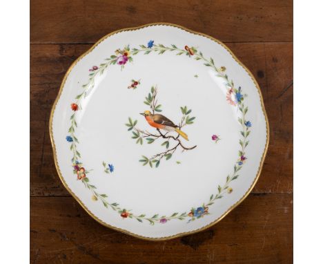 A Loosdrecht ornithological dish With a central painted bird surrounded by a floral motif and a shaped gilt rim. C.1780. Unde