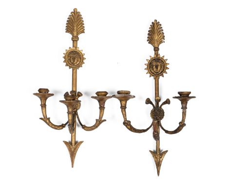 A pair of gilt French Empire wall sconces The arrow-carved bodies with mask roundels, supporting three branches59cm tallQty: 