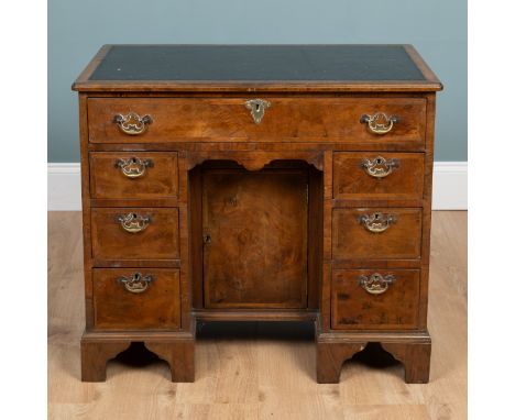 A Georgian burr walnut kneehole desk The seven drawers with herringbone inlay arranged around a central kneehole cupboard rai