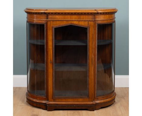 A 19th century mahogany credenza The glazed door and panels with carved slips enclosing two shelves. 115cm wide x 37cm deep x