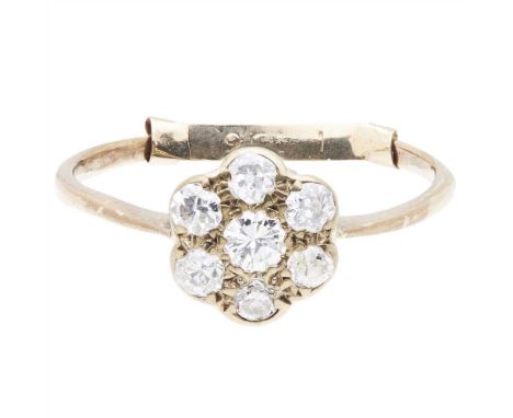 A diamond cluster ring claw set with seven round cut diamonds, to a plain unmarked yellow metal shank (Dimensions: Ring size: