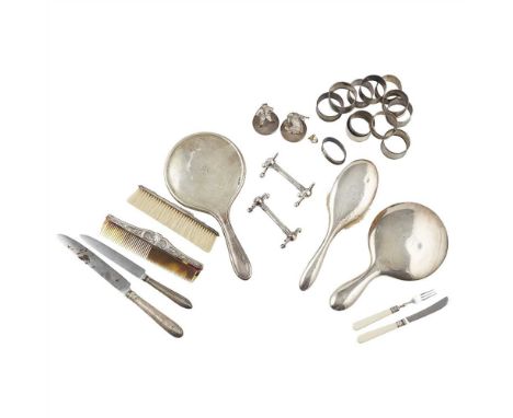 A collection of dressing table brushes and miscellaneous silver to include; various napkin rings; mother of pearl and silver 