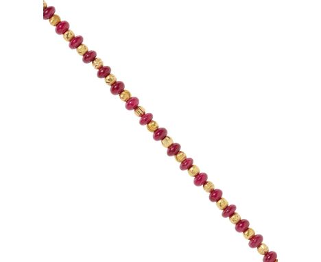 A ruby bead necklace comprised of twenty-four polished ruby beads of graduated sizes between faceted and bright cut yellow me