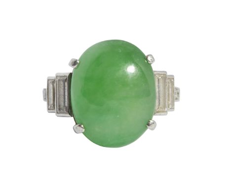 An Art Deco jadeite and diamond set ring claw set with an oval jadeite cabochon, each shoulder collet set with two graduated 