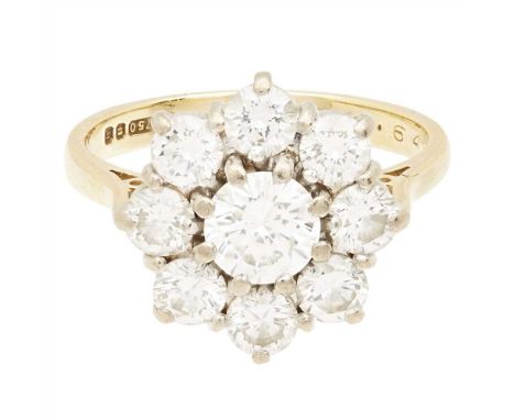 A diamond set cluster ring claw set with a round brilliant cut diamond, in a border of eight smaller round brilliant cut diam