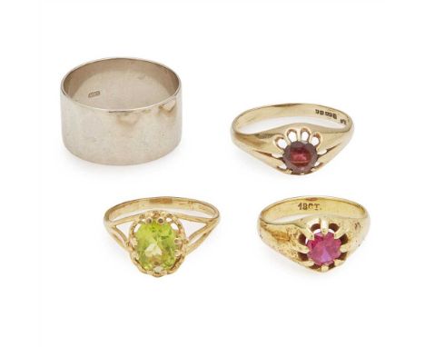 A collection of four rings to include a broad 18ct white gold wedding band, a 9ct gold peridot set ring; a 9ct gold garnet se