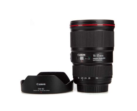 CANON ZOOM EF 16-35MM 1:4L IS USM LENS,complete with front and rear caps and lens hoodMounting ring and body shows light sign