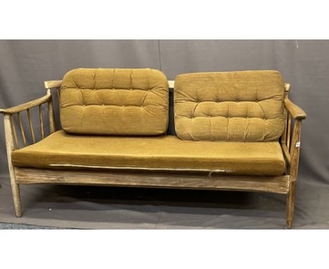 DANISH STYLE TEAK SPINDLE BACK SETTEE with unusual lift and drop-down arm, 68cms H, 166cms W, 70cms D Auctioneer's Note: The 