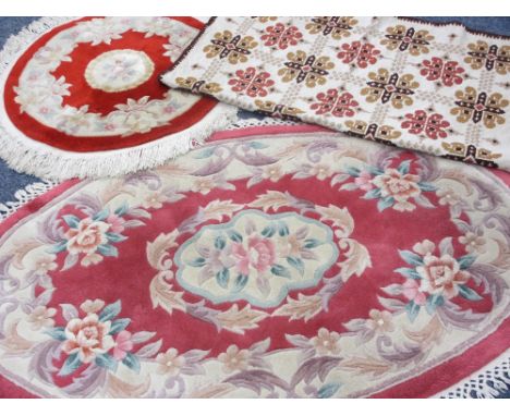 CHINESE WASHED RUGS, oval - 155 x 93cms, circular - 85cms diameter and a tapestry