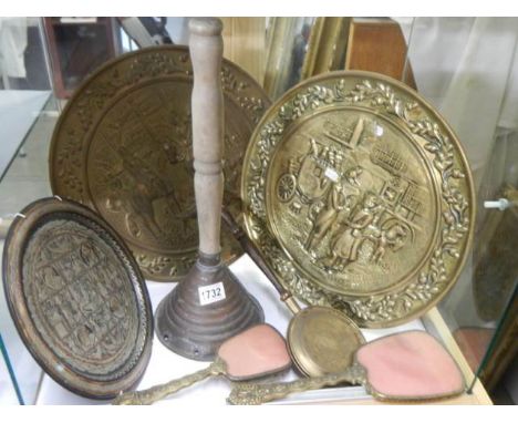 A shelf of assorted brass ware.
