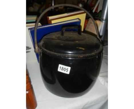 An old enamel cooking pot with lid.