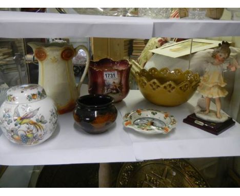 A shelf of assorted ceramics.